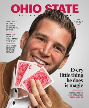 man smiling holding a deck of playing cards