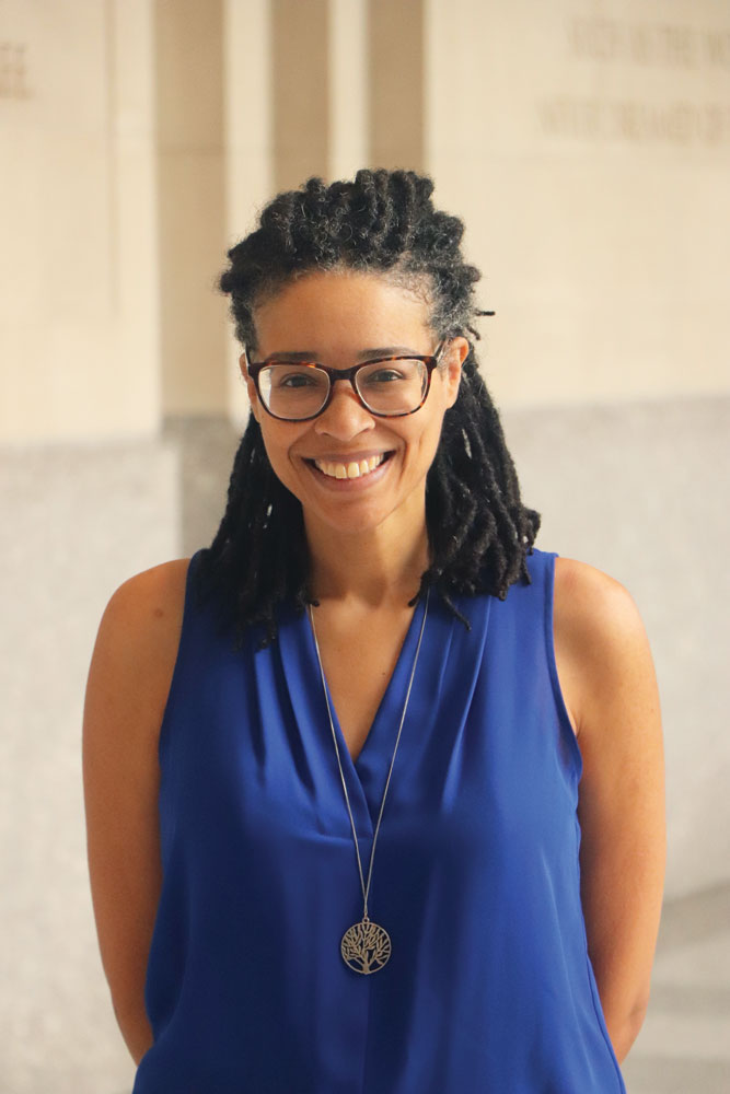 Jennifer Eaglin poses for a simple portrait, grinning and wearing glasses and sleeveless top. She looks like she'd also be a great person to take a class from.