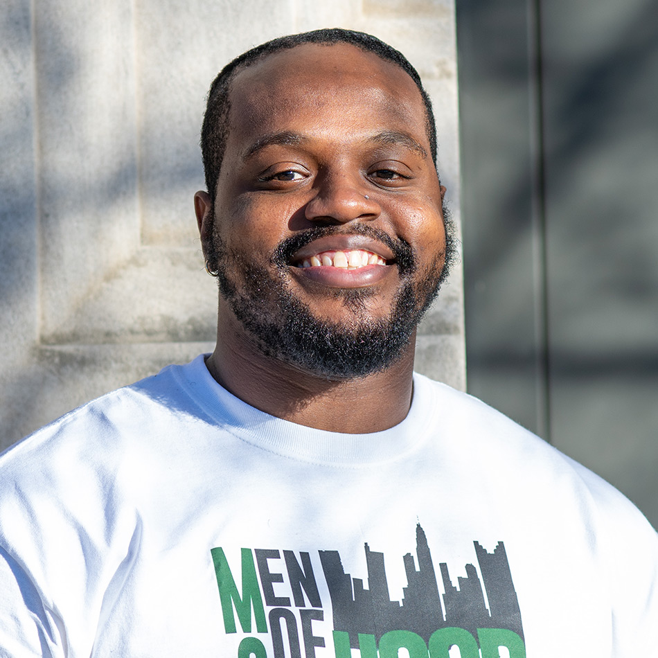 portrait of Joe Ingram smiling outdoors wearing a t-shirt