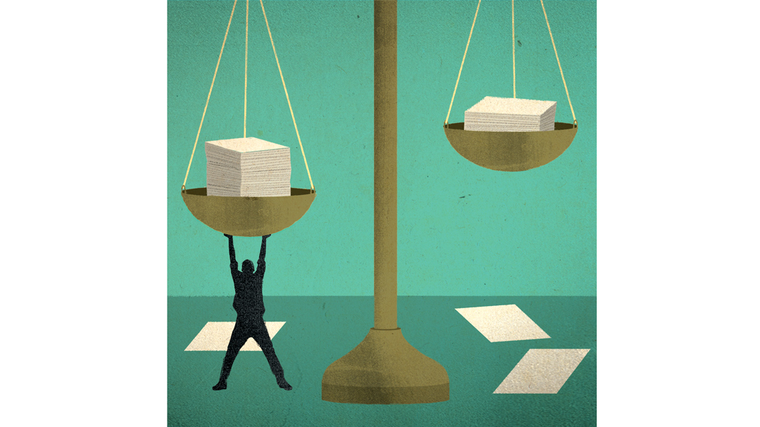 A man reaches overhead to support one side of a scale 