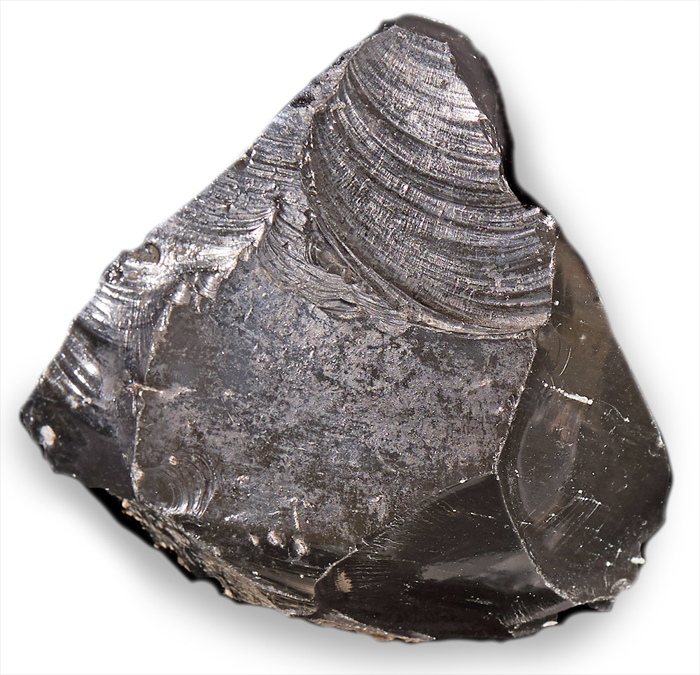 A carved piece of obsidian as roughly shaped like an arrow head, but its size is unclear from the image.