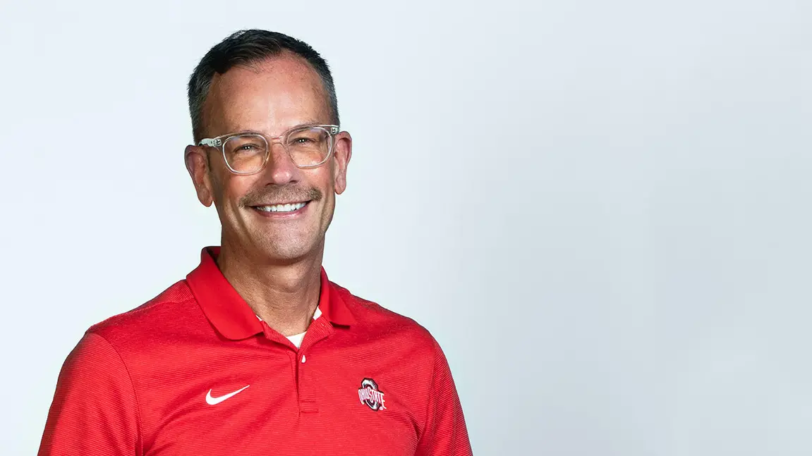 matt hall wearing a red ohio state polo smiling at camera