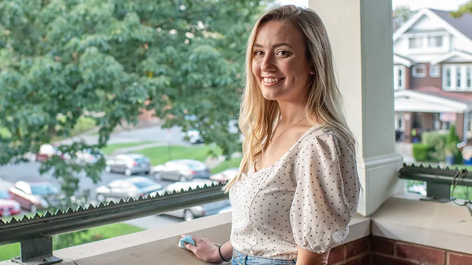 taylor gruenwald standing on balcony