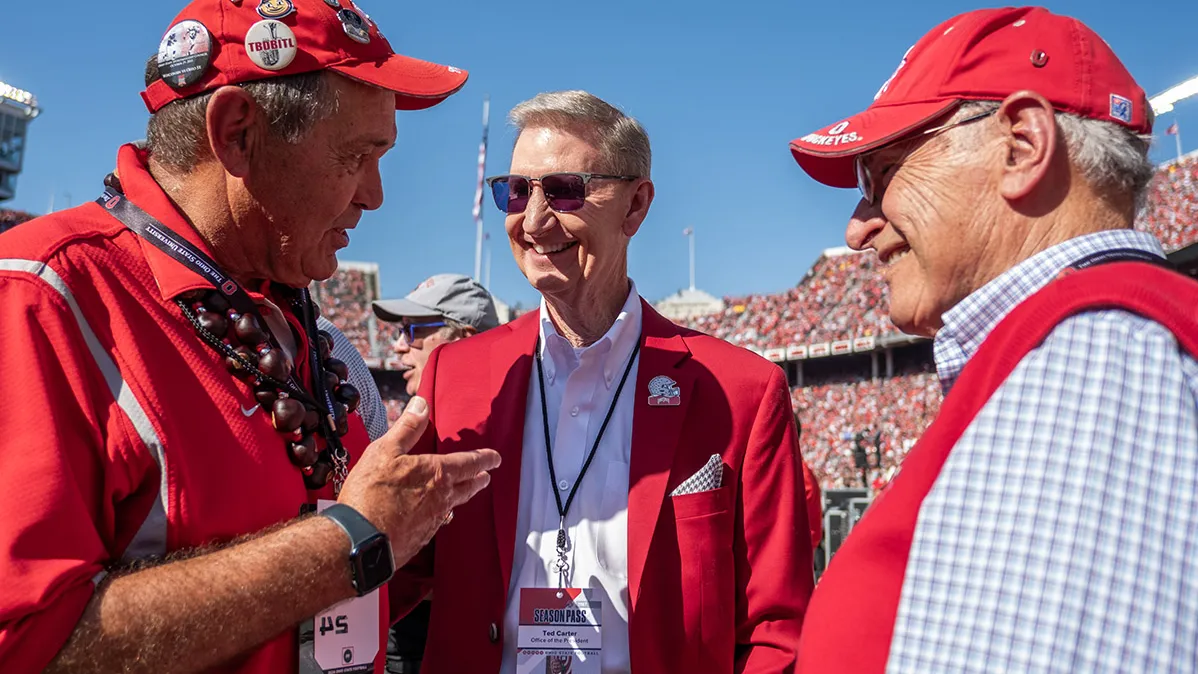 President Carter is flanked by two Ohio State alumni at a football game