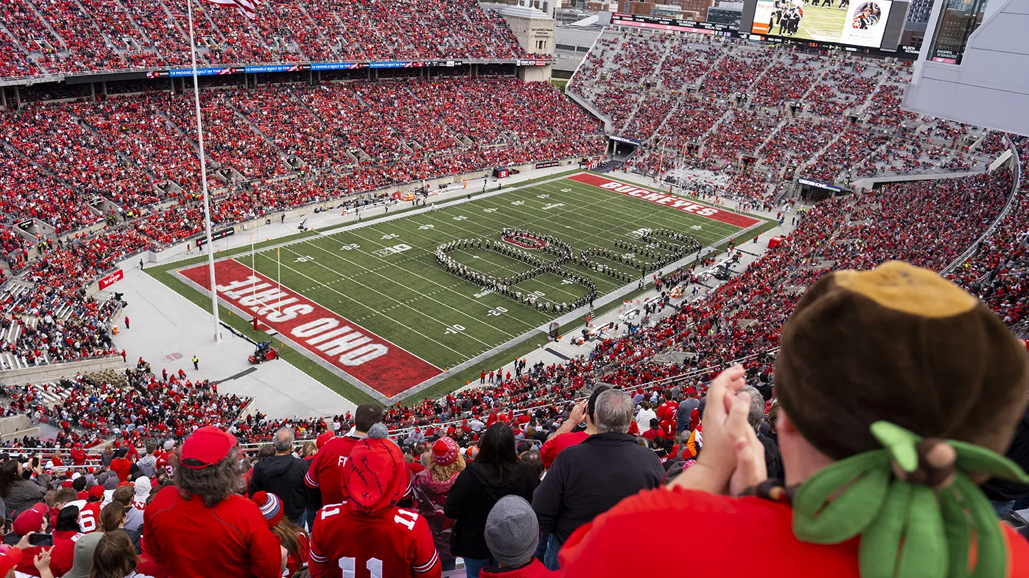 Seen from far up in the stands in Ohio Stadium, the Ohio State Marching Band performs Script Ohio in the 2022 football season.