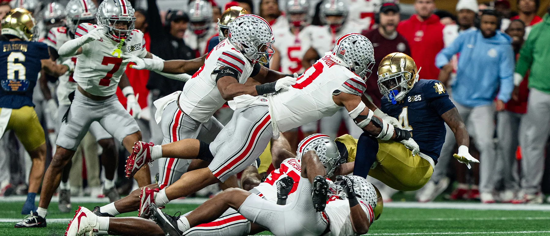 A whole bunch of Ohio State players tackle a Notre Dame player