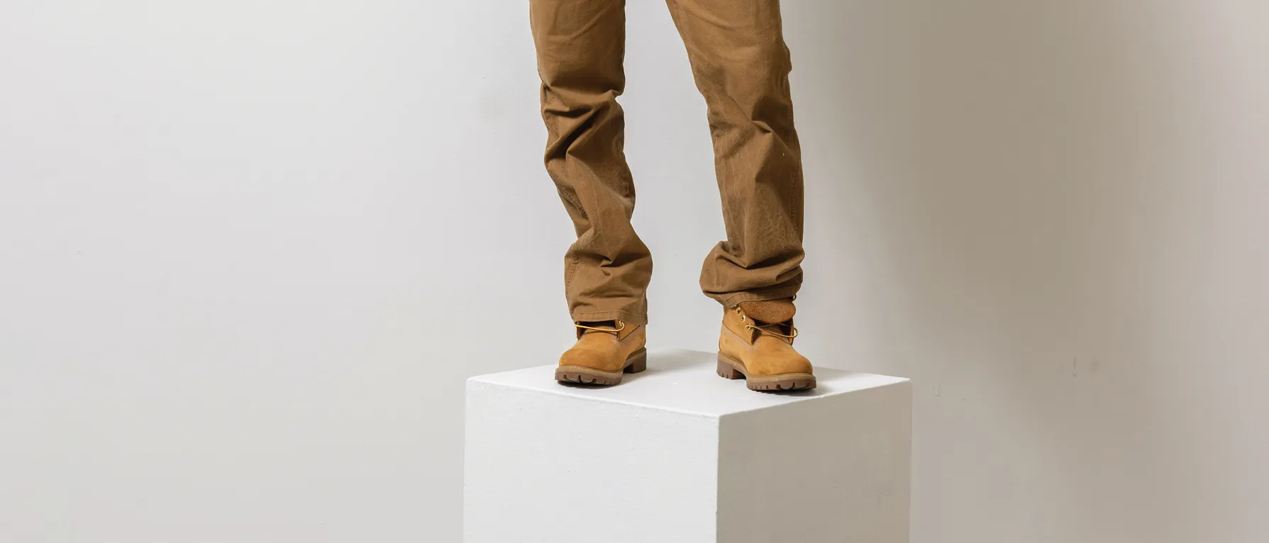 Terron Banner's feet and lower legs. He wears tan boots and tan jeans