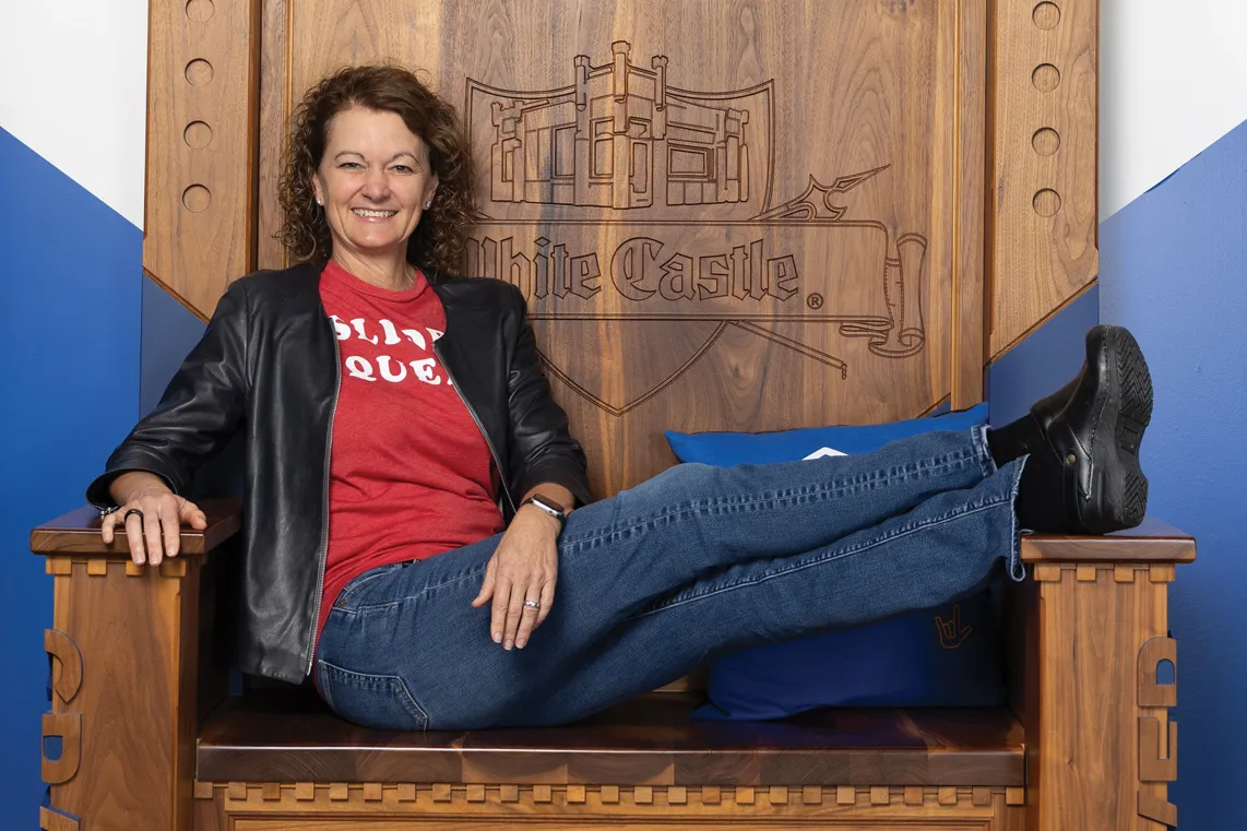 Lisa Ingram laughs as she lounges in the White Castle throne in the company's Craver museum, a favorite destination for customer enthusiasts.