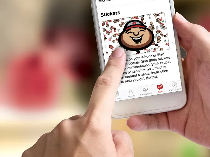 Close up of hands holding a smartphone displaying the app developed for OSU alumni