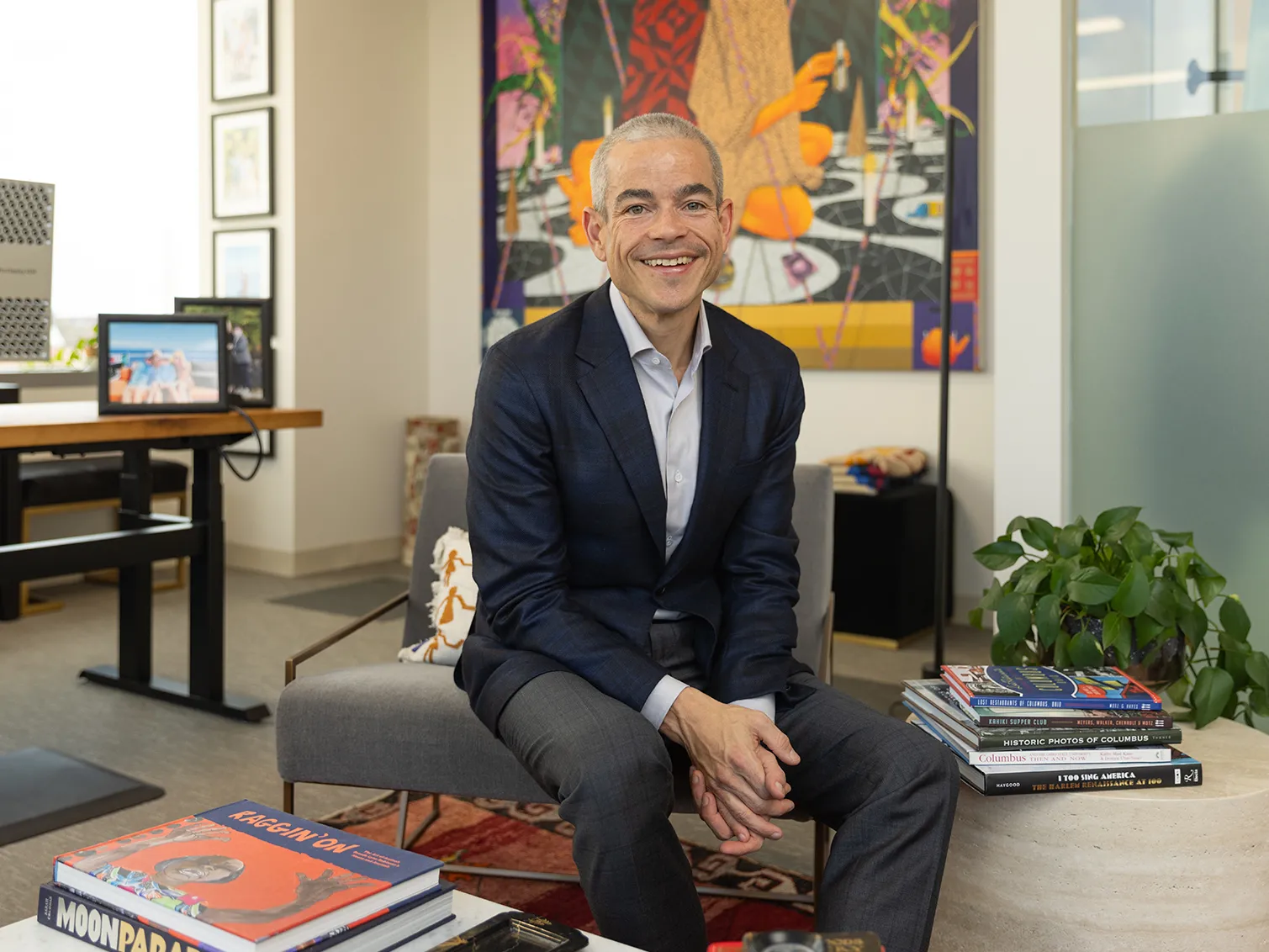Matt Scantland smiles as he poses for a portrait in his office. He's a thin, white, middle age man with close cropped hair wearing a sport coat. His smile is genuine.