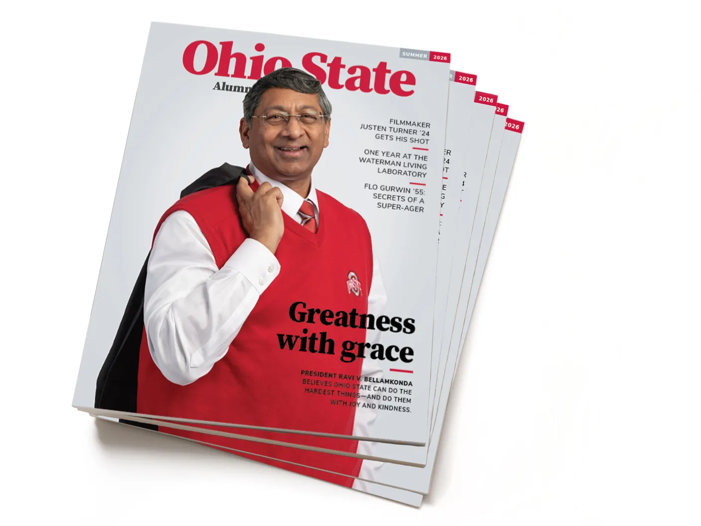 A stack of summer 2026 issues of Ohio State Alumni Magazine show teh university president with a big smile and his jacket hooked over his shoulder. He also wears a sweater vest